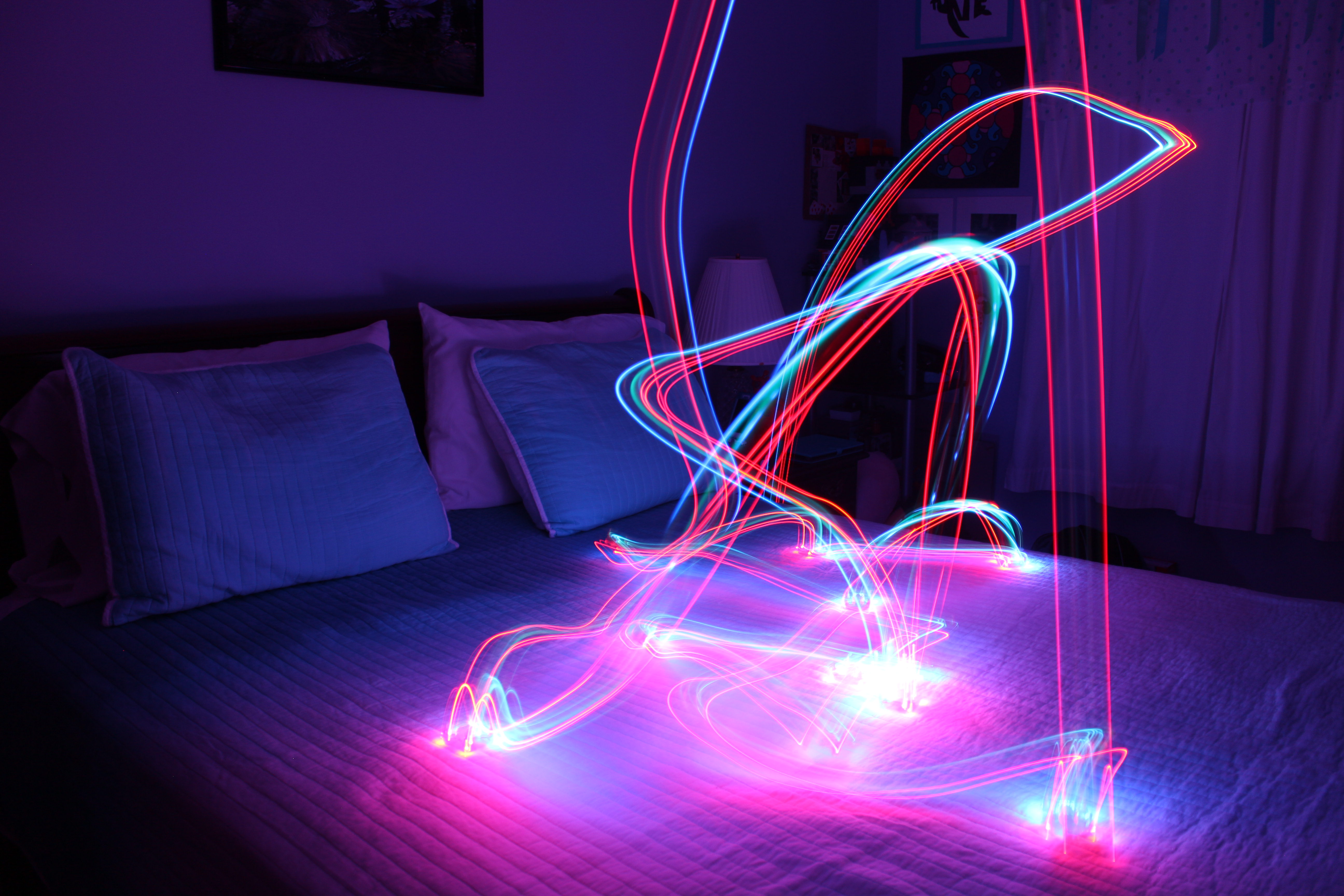 Drone A red and blue light trail from a mini-drone illuminates a bedroom.