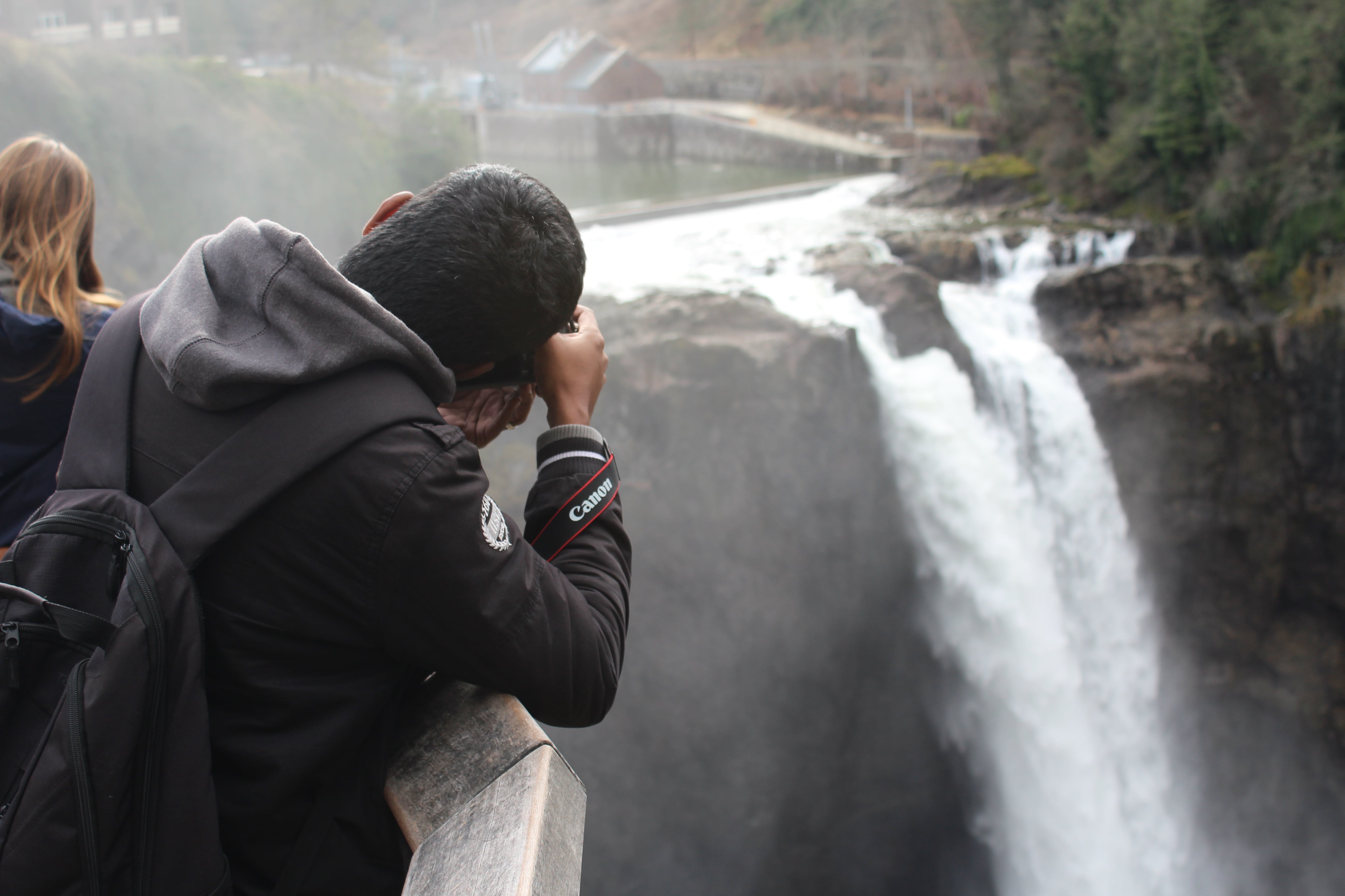 A photographer taking a photo of Snoqualmie Falls